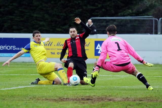Brackley Town's Steve Diggin is squeezed out by Chorley keeper Richie Branagan and Scott Leather