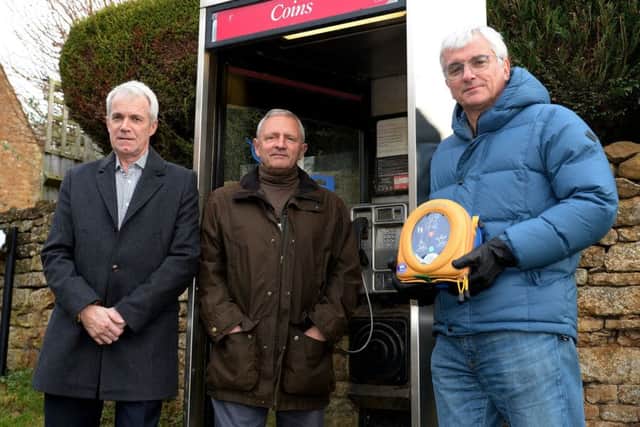 The Hornton phone box is scheduled for removal. Concerned parish councillors, from the left, Roger Bellamy, Tim Hewlett and chairman, John Offord with the village defibrillator. NNL-171001-152812009