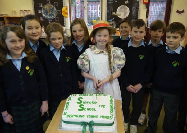 Sofia Mattinson cuts the birthday cake at Sibford School