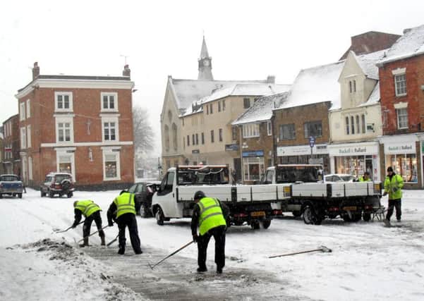 MHBG... Council workers clear the snow, in Market Place, Banbury, in the early morning of Wednesday 13th January 2010