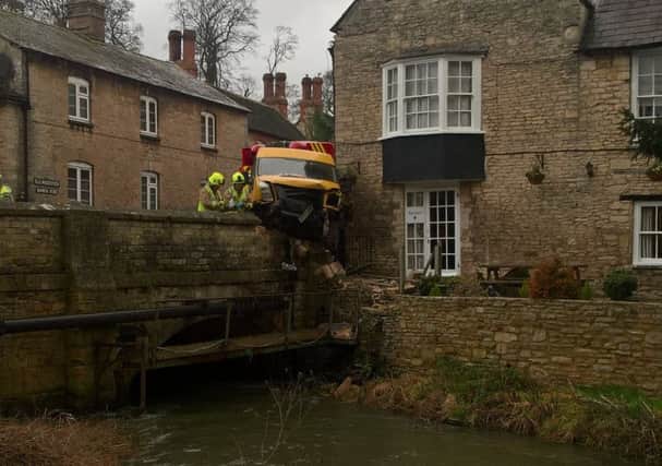 A van crashed into a wall and nearly ended up in the river in Woodstock. NNL-170302-114649001