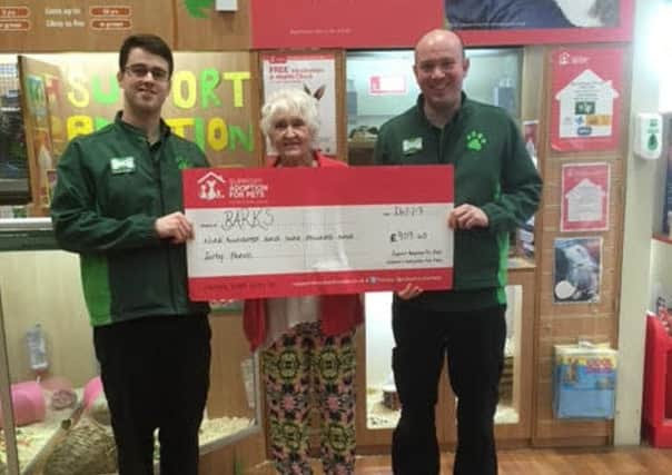 BARKS trustee Joyce Turner receives the cheque from Pets at Home