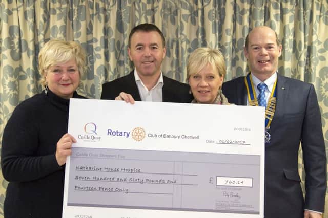 A cheque for Â£760 is handed over to Katharine House Hospice