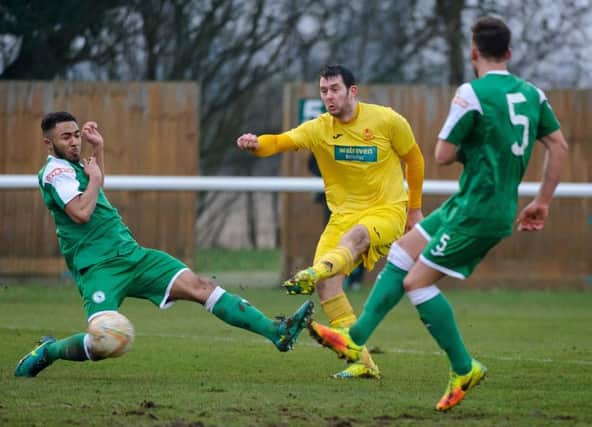 Banbury United's Ricky Johnson gets in a shot at Biggleswade Town. Photo: Guy Wills
