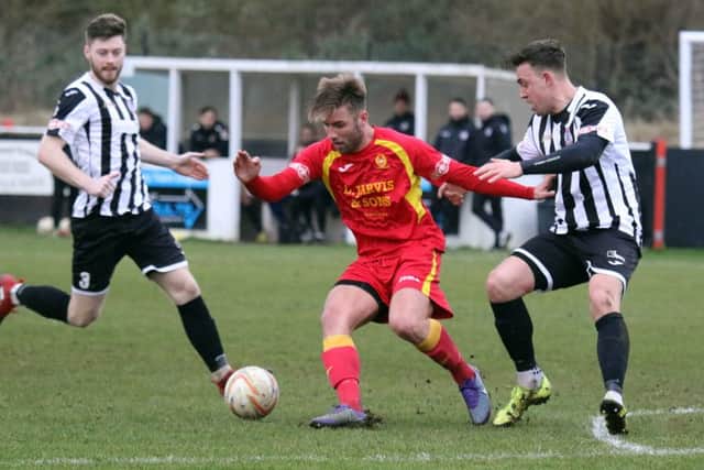 Banbury United's Conor McDonagh holds off  St Ives Town's Liam McDevitt