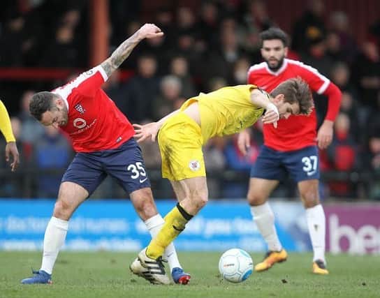 York City's Danny Holmes and Brackley Towns James Armson get in a tangle. Photo: Gordon Clayton