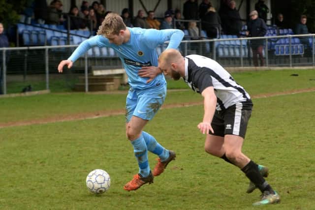 Ardley United's Matt Cruse is held off by a Lydney Town defender