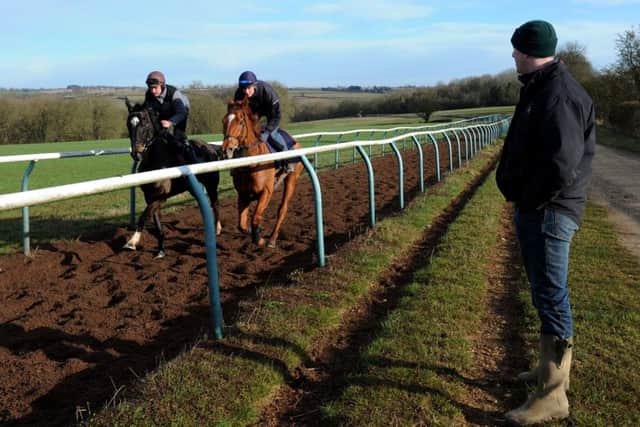 Chipping Norton trainer Charlie Longsdon looks on as Our Kaempfer (Sam Painting) and Copernicus (Richard Leadley) come up the Hull Farm gallops