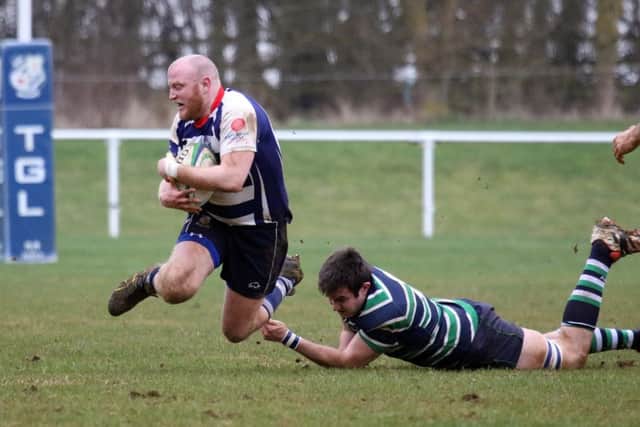 Banbury Bulls' Chris Phillips is tackled by Reading Abbey's David Cole at Bodicote Park