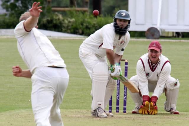 Banbury bowler Richard West sends down a delivery to Slough batsman Fahim Qureshi as wicket keeper Eddie Phillips looks on