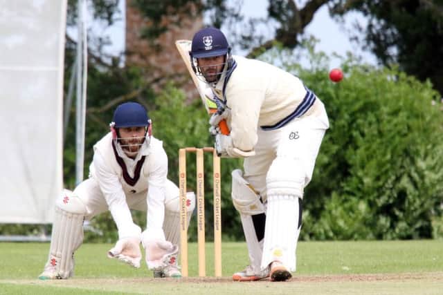 High Wycombe batsman Nathan Hawkes on his way to a century as Great & Little Tew wicket keeper Robbie Catling gets set
