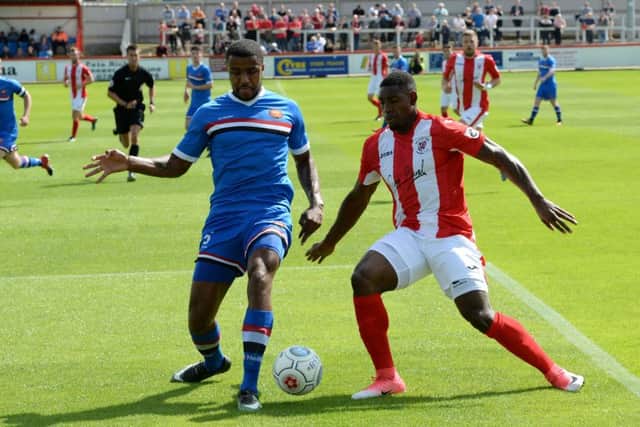 Lee Ndlovu, taking on FC United of Manchester's Jordan Fagbola, scored for Saints on Tuesday