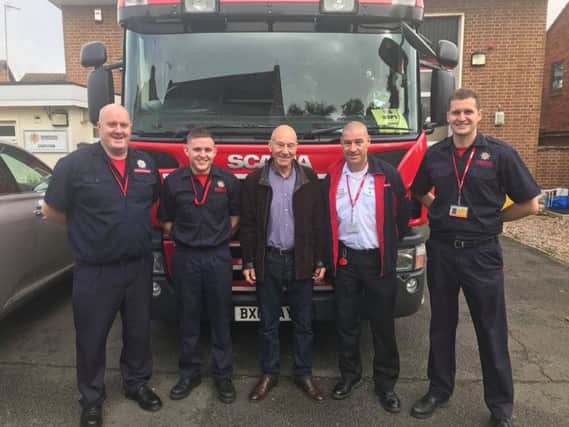 'To boldly go where no fire crew has gone before': Alcester firefighters with Sir Patrick Stewart after changing his tyre. Photo: Warwickshire Fire and Rescue Service