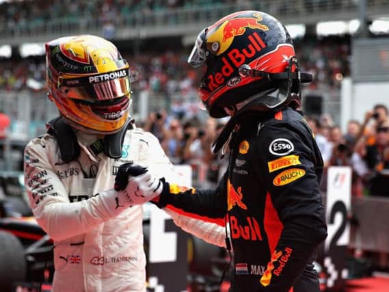Max Verstappen is congratulated by Lewis Hamilton