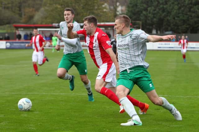 Brackley Town's Andy Brown is challenged by Blyth Spartans' Nathan Buddle and Ryan Hutchinson