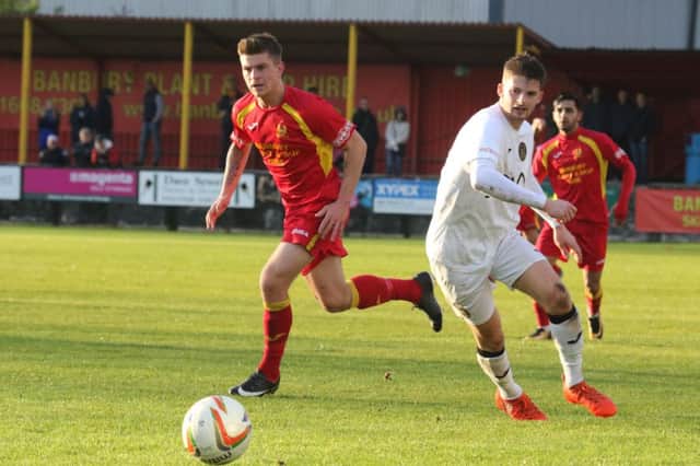 Banbury United's Charlie Hawtin launches another attack against Tiverton Town